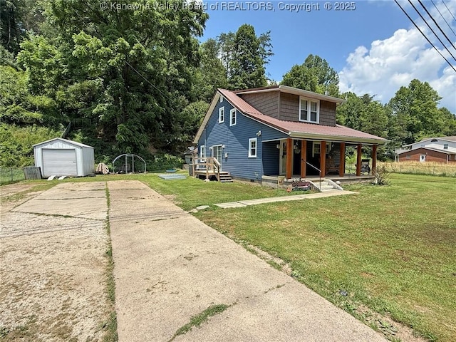 1255 Johns Creek Rd, Milton, WV 25541 - view of front of home featuring concrete driveway, an outbuilding, a front yard, and covered porch