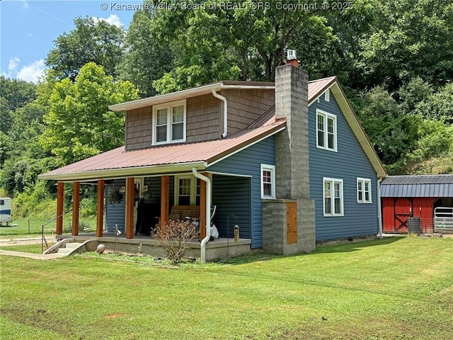 1255 Johns Creek Rd, Milton, WV 25541 - rear view of property with a chimney, a yard, a metal roof, covered porch, and an outbuilding