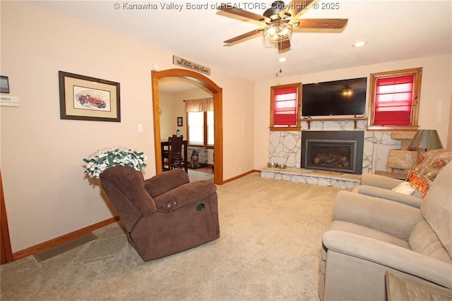 1255 Johns Creek Rd, Milton, WV 25541 - living area with arched walkways, ceiling fan, carpet flooring, a stone fireplace, and recessed lighting