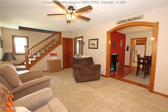 1255 Johns Creek Rd, Milton, WV 25541 - living area with arched walkways, ceiling fan, carpet, and stairway
