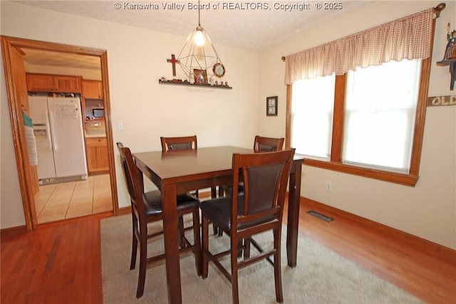 1255 Johns Creek Rd, Milton, WV 25541 - dining space featuring light wood finished floors and a textured ceiling
