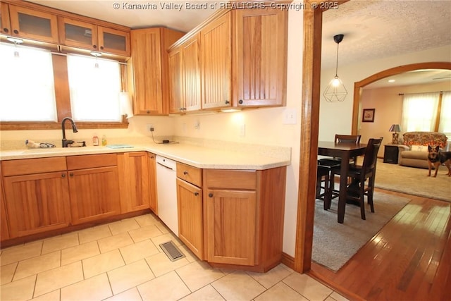 1255 Johns Creek Rd, Milton, WV 25541 - kitchen featuring arched walkways, dishwasher, light countertops, glass insert cabinets, and open floor plan