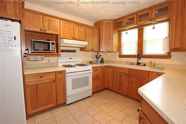 1255 Johns Creek Rd, Milton, WV 25541 - kitchen with white appliances, under cabinet range hood, light countertops, and light tile patterned flooring