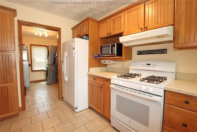 1255 Johns Creek Rd, Milton, WV 25541 - kitchen with white appliances, under cabinet range hood, light tile patterned floors, and brown cabinets
