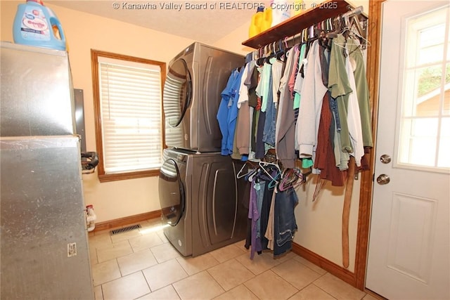 1255 Johns Creek Rd, Milton, WV 25541 - laundry area featuring stacked washing machine and dryer and tile patterned flooring