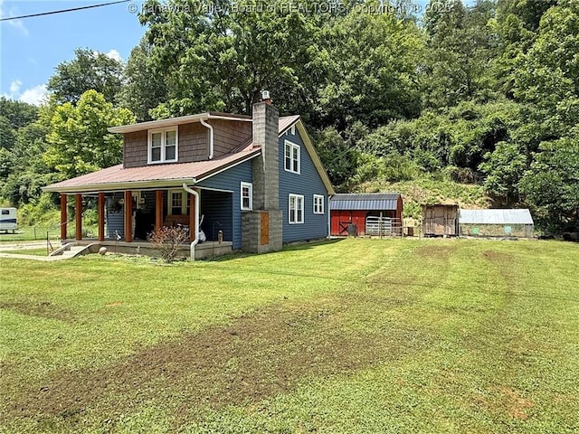 1255 Johns Creek Rd, Milton, WV 25541 - view of front facade with a porch, a front lawn, a chimney, and a metal roof