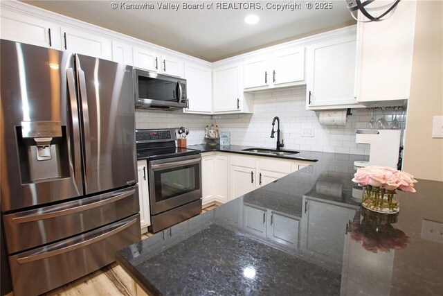 1412 Wilkie Dr, Charleston, WV 25314 - kitchen featuring appliances with stainless steel finishes, white cabinets, and backsplash