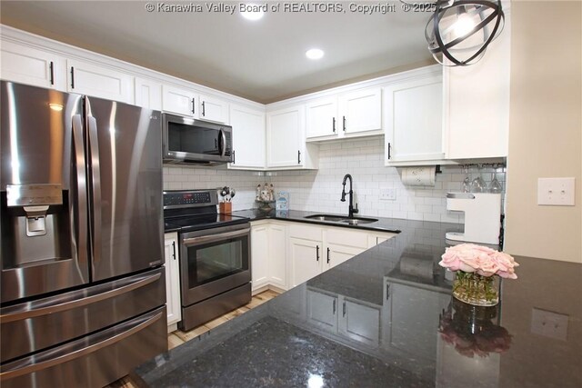1412 Wilkie Dr, Charleston, WV 25314 - kitchen with appliances with stainless steel finishes, white cabinets, and tasteful backsplash