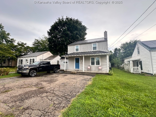 191 N Park Dr, Point Pleasant, WV 25550 - view of front of home featuring a porch, a chimney, a front lawn, and a metal roof