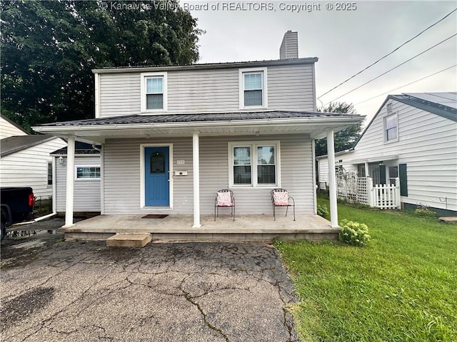 191 N Park Dr, Point Pleasant, WV 25550 - view of front of house with covered porch, a front lawn, a chimney, and a metal roof