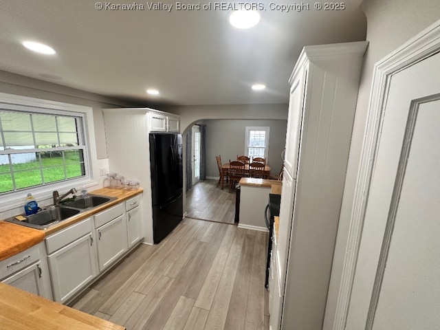 191 N Park Dr, Point Pleasant, WV 25550 - kitchen with freestanding refrigerator, arched walkways, white cabinets, light wood-style floors, and recessed lighting