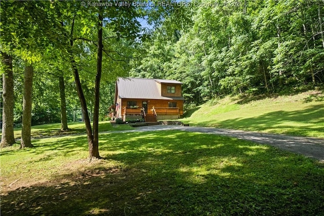 180 Tryphenia Rd, Hurricane, WV 25526 - view of front of home featuring stairway, a front lawn, a metal roof, and a forest view