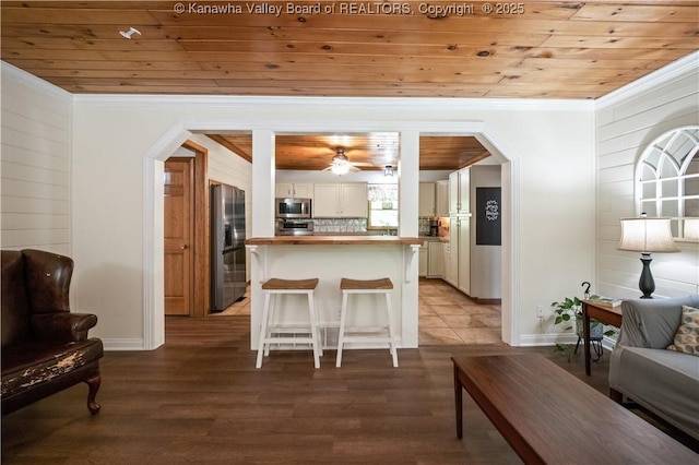 180 Tryphenia Rd, Hurricane, WV 25526 - living area featuring wooden ceiling, light wood-type flooring, crown molding, wood walls, and arched walkways