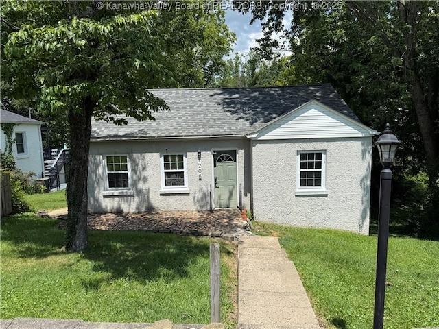 1206 Central Ave, Saint Albans, WV 25177 - view of front of house featuring a front lawn, stucco siding, and roof with shingles