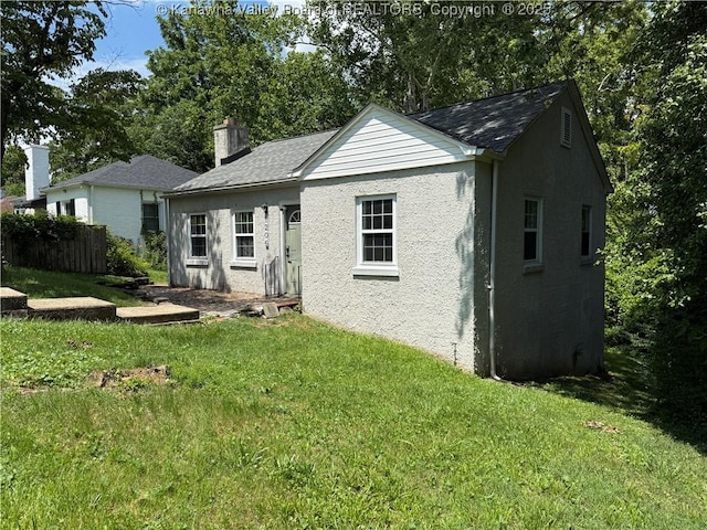 1206 Central Ave, Saint Albans, WV 25177 - rear view of house with a lawn, a chimney, and a shingled roof