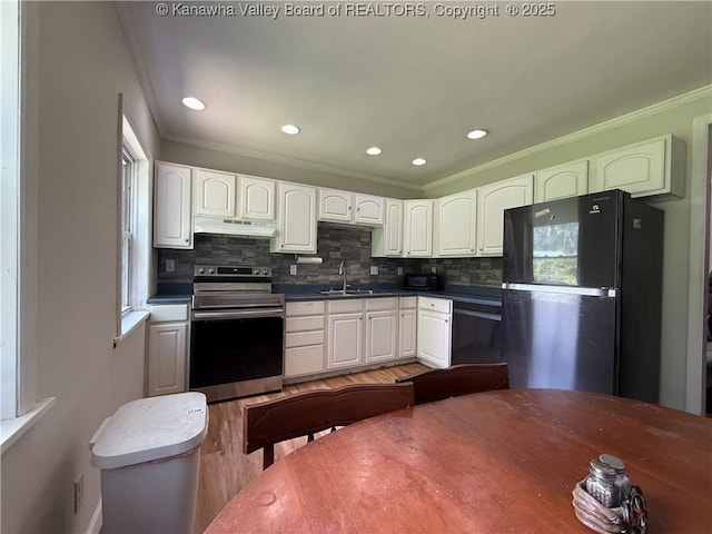 1206 Central Ave, Saint Albans, WV 25177 - kitchen featuring stainless steel range with electric cooktop, freestanding refrigerator, under cabinet range hood, crown molding, and light wood-style floors