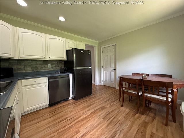 1206 Central Ave, Saint Albans, WV 25177 - kitchen with freestanding refrigerator, dishwashing machine, dark countertops, tasteful backsplash, and light wood finished floors