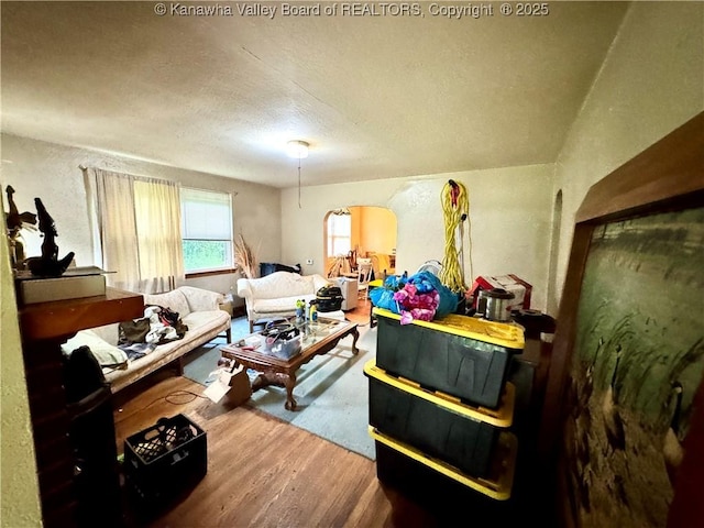 17739 US Route 60, Culloden, WV 25510 - living area with wood finished floors, arched walkways, and a textured ceiling