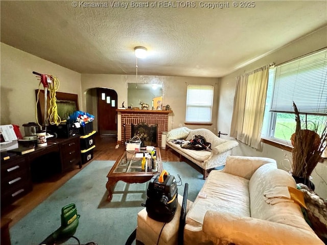 17739 US Route 60, Culloden, WV 25510 - living area with arched walkways, a textured ceiling, and a brick fireplace