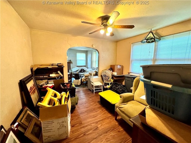 17739 US Route 60, Culloden, WV 25510 - bedroom featuring wood finished floors, arched walkways, a textured ceiling, and a ceiling fan