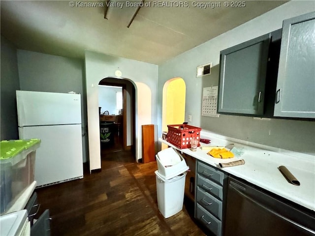17739 US Route 60, Culloden, WV 25510 - kitchen featuring freestanding refrigerator, dark wood-style flooring, light countertops, dishwasher, and arched walkways