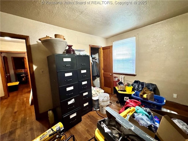 17739 US Route 60, Culloden, WV 25510 - bedroom featuring wood finished floors, a textured wall, a textured ceiling, and a closet