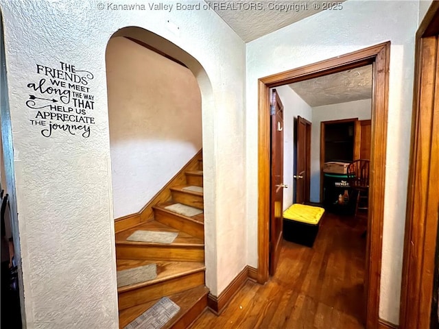17739 US Route 60, Culloden, WV 25510 - stairway featuring a textured wall, wood finished floors, arched walkways, and a textured ceiling