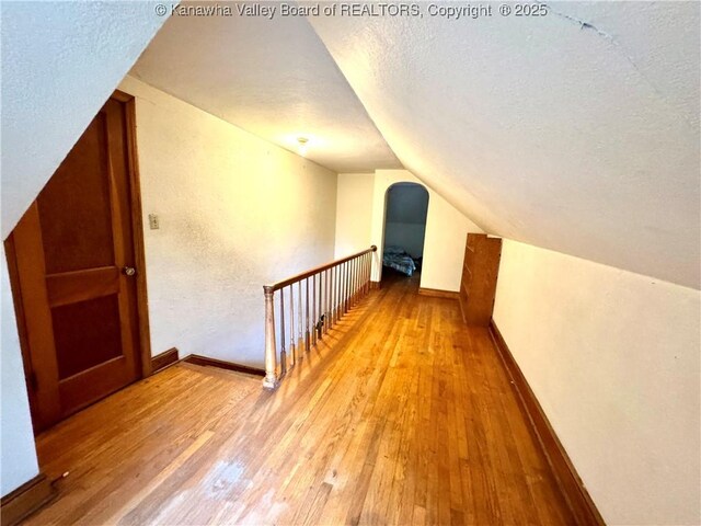 17739 US Route 60, Culloden, WV 25510 - additional living space featuring a textured ceiling, vaulted ceiling, and hardwood / wood-style flooring