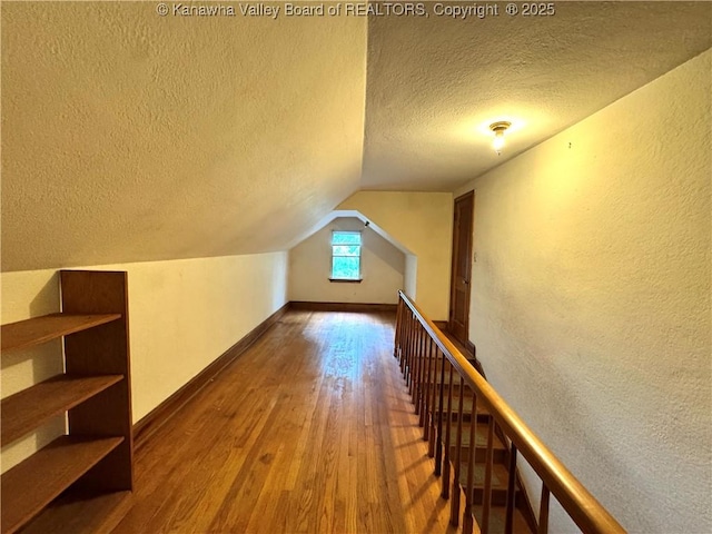 17739 US Route 60, Culloden, WV 25510 - bonus room featuring a textured ceiling, hardwood / wood-style flooring, a textured wall, and vaulted ceiling