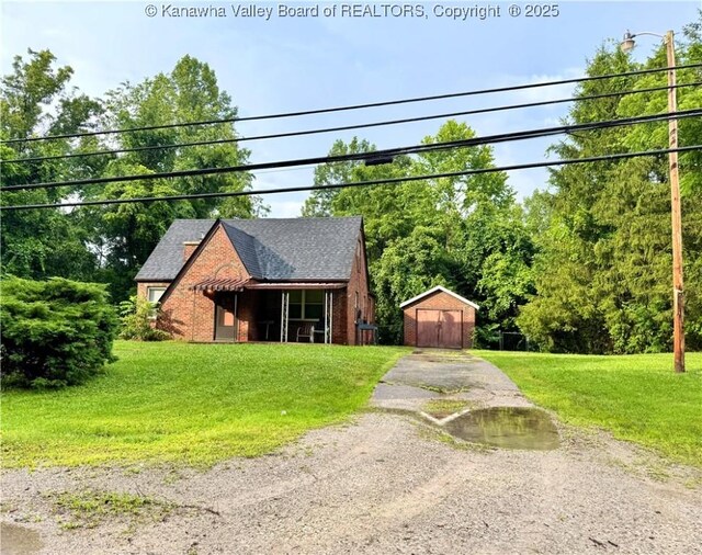 17739 US Route 60, Culloden, WV 25510 - view of front of home with driveway, an outbuilding, a front yard, and brick siding