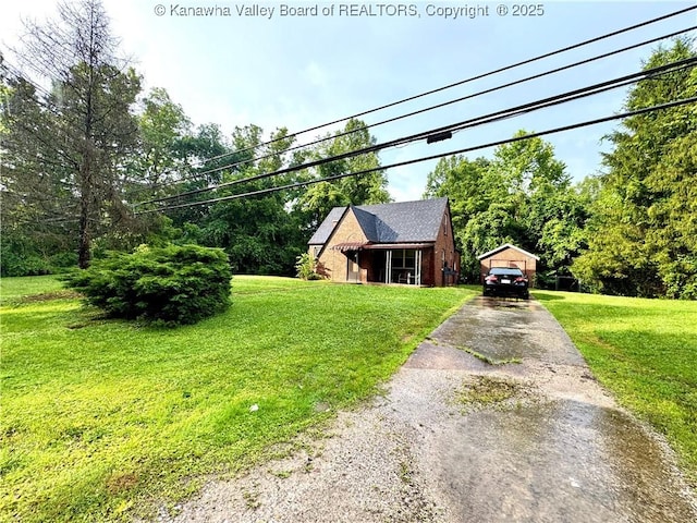 17739 US Route 60, Culloden, WV 25510 - view of front of house with concrete driveway, a front yard, an outdoor structure, and a detached carport