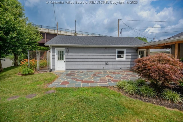 1516 Fenton Cir, Nitro, WV 25143 - rear view of property with a shingled roof and a patio area