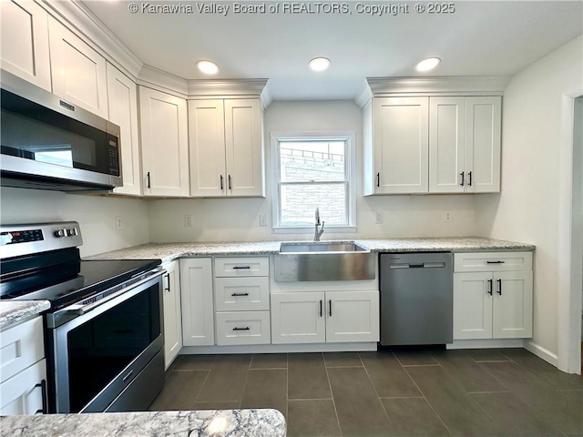 1516 Fenton Cir, Nitro, WV 25143 - kitchen with appliances with stainless steel finishes, white cabinetry, dark tile patterned floors, recessed lighting, and light stone counters
