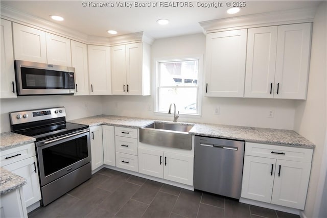 1516 Fenton Cir, Nitro, WV 25143 - kitchen featuring appliances with stainless steel finishes, white cabinets, light stone counters, and recessed lighting