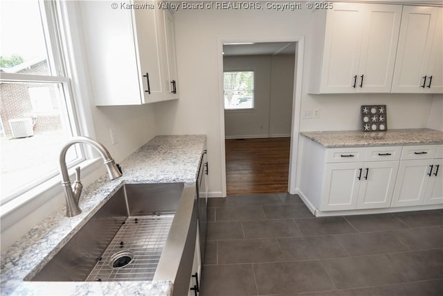 1516 Fenton Cir, Nitro, WV 25143 - kitchen featuring dark tile patterned floors, white cabinets, and light stone counters