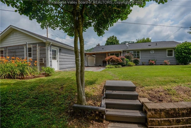 1516 Fenton Cir, Nitro, WV 25143 - back of house featuring a lawn