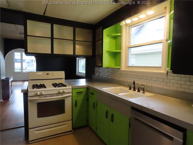 4808 Kentucky St, South Charleston, WV 25309 - kitchen with white gas stove, stainless steel dishwasher, backsplash, light countertops, and open shelves