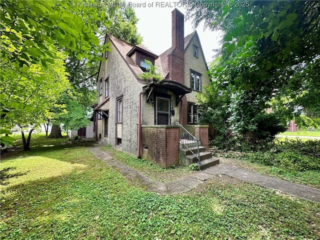 5430 Virginia Ave SE, Charleston, WV 25304 - view of property exterior with a yard, a chimney, and brick siding