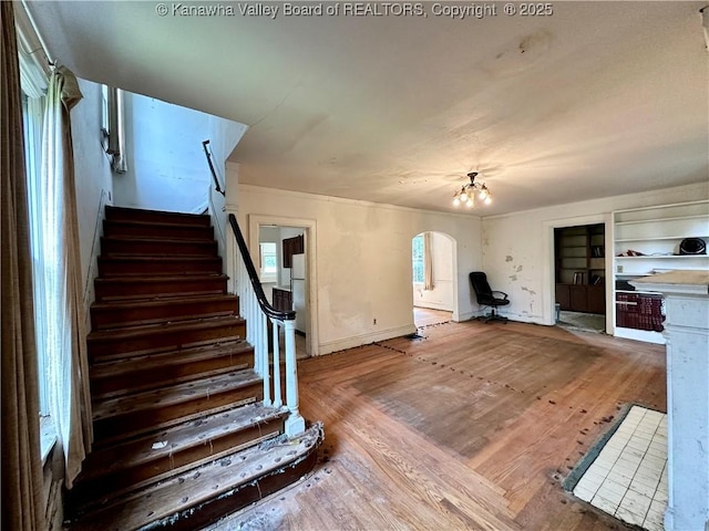 5430 Virginia Ave SE, Charleston, WV 25304 - stairs featuring arched walkways, wood finished floors, and a chandelier