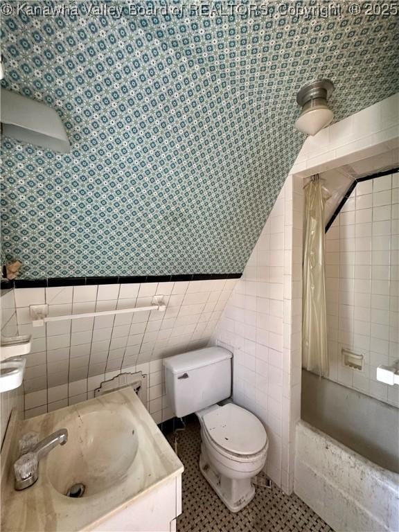 5430 Virginia Ave SE, Charleston, WV 25304 - full bathroom with tile walls, vanity, tiled shower / bath combo, and a wainscoted wall