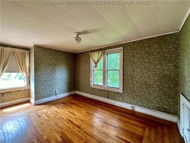 5430 Virginia Ave SE, Charleston, WV 25304 - unfurnished room featuring plenty of natural light, hardwood / wood-style flooring, wallpapered walls, and ornamental molding
