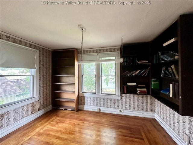 5430 Virginia Ave SE, Charleston, WV 25304 - unfurnished room featuring wallpapered walls, plenty of natural light, and wood finished floors