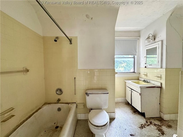 5430 Virginia Ave SE, Charleston, WV 25304 - full bathroom featuring tile walls, vanity, shower / bath combination, tile patterned flooring, and a wainscoted wall