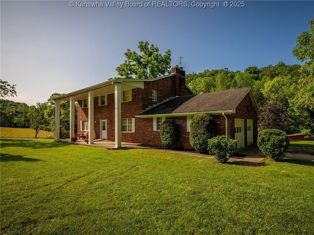 1846 Scott Depot Rd, Scott Depot, WV 25560 - view of front of house featuring a front lawn, brick siding, a chimney, and an attached garage
