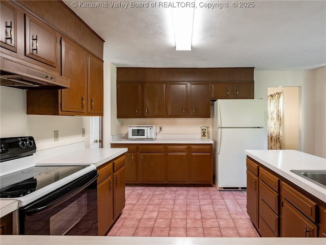 1846 Scott Depot Rd, Scott Depot, WV 25560 - kitchen with white appliances, light countertops, under cabinet range hood, and light tile patterned flooring
