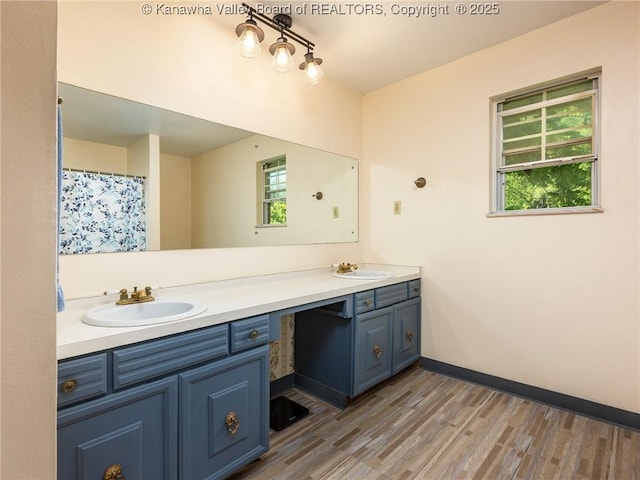 1846 Scott Depot Rd, Scott Depot, WV 25560 - bathroom featuring double vanity, wood finished floors, and healthy amount of natural light