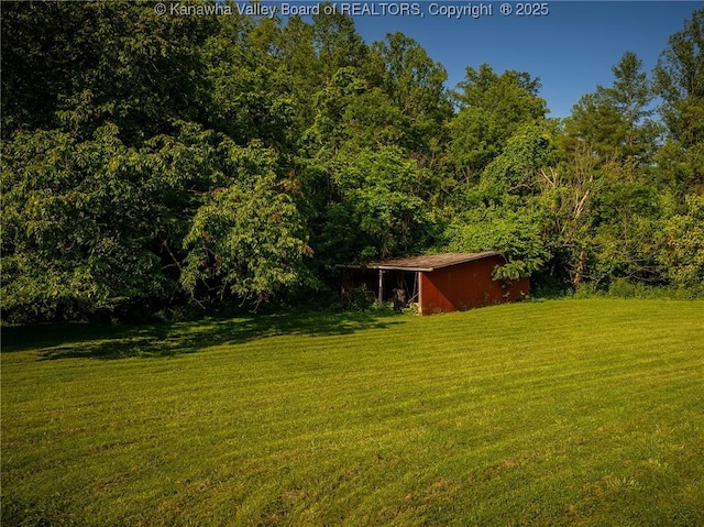 1846 Scott Depot Rd, Scott Depot, WV 25560 - view of grassy yard with an outbuilding, an outdoor structure, and a forest view