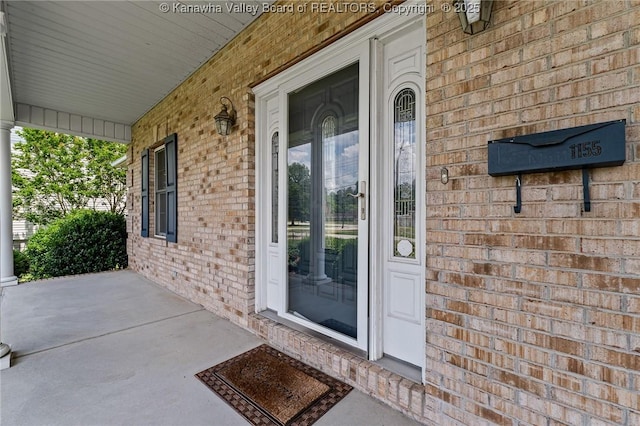 1155 Pike St, Milton, WV 25541 - entrance to property with covered porch and brick siding
