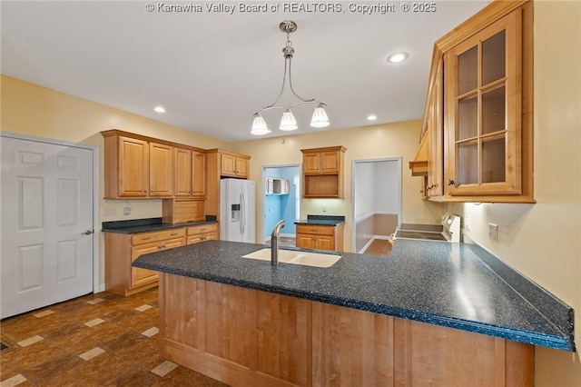 1155 Pike St, Milton, WV 25541 - kitchen with white fridge with ice dispenser, range, a peninsula, glass insert cabinets, and dark countertops
