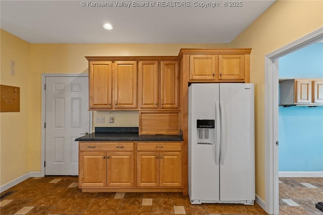 1155 Pike St, Milton, WV 25541 - kitchen with white fridge with ice dispenser, recessed lighting, and dark stone countertops